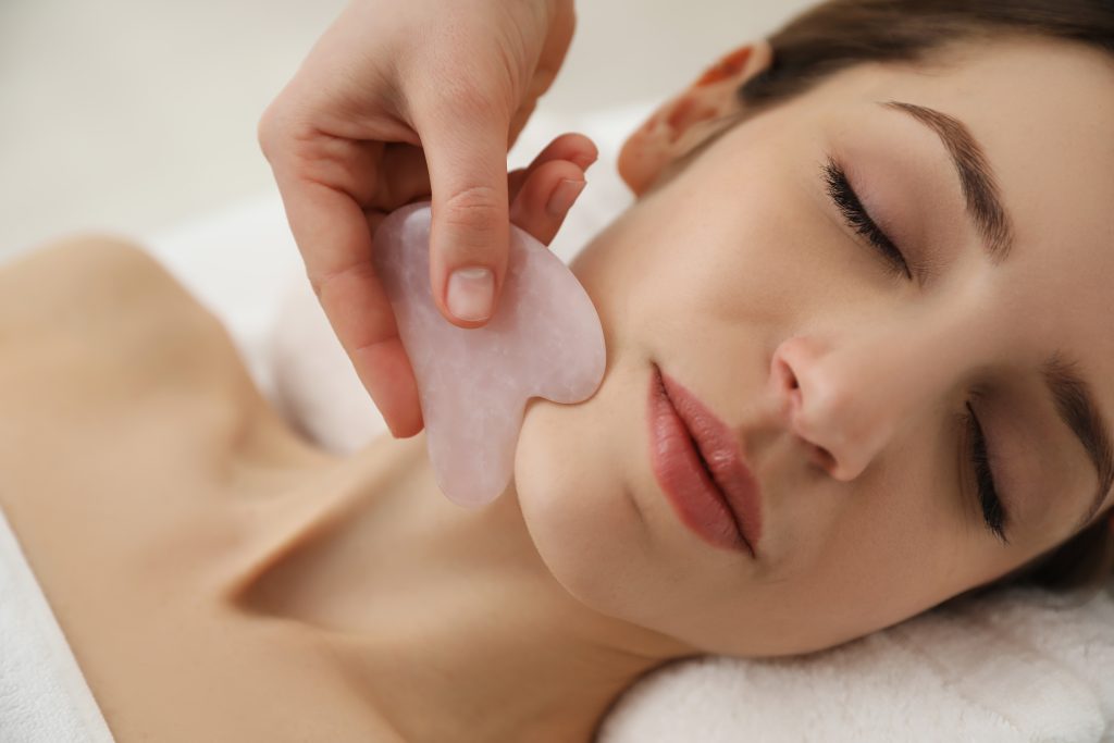 young woman receiving facial massage