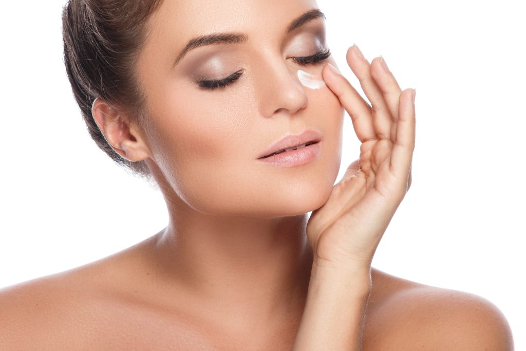 women applying moisturizer